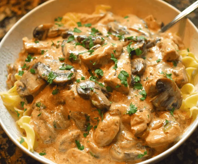Creamy Chicken Stroganoff served over noodles with mushrooms and herbs, perfect for a hearty and comforting meal.