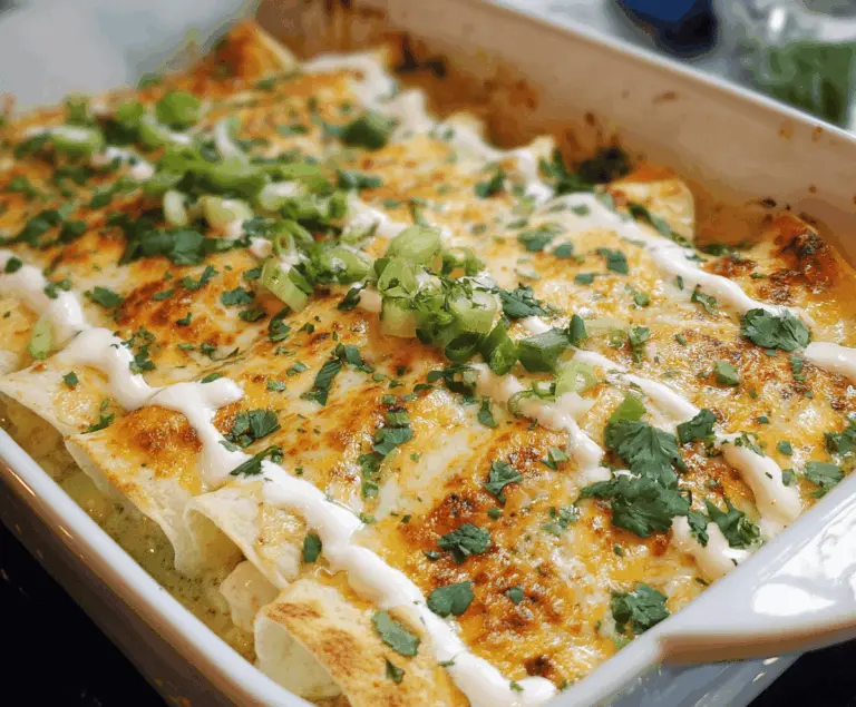 Delicious low carb white chicken enchiladas topped with melted cheese and fresh cilantro, served on a plate