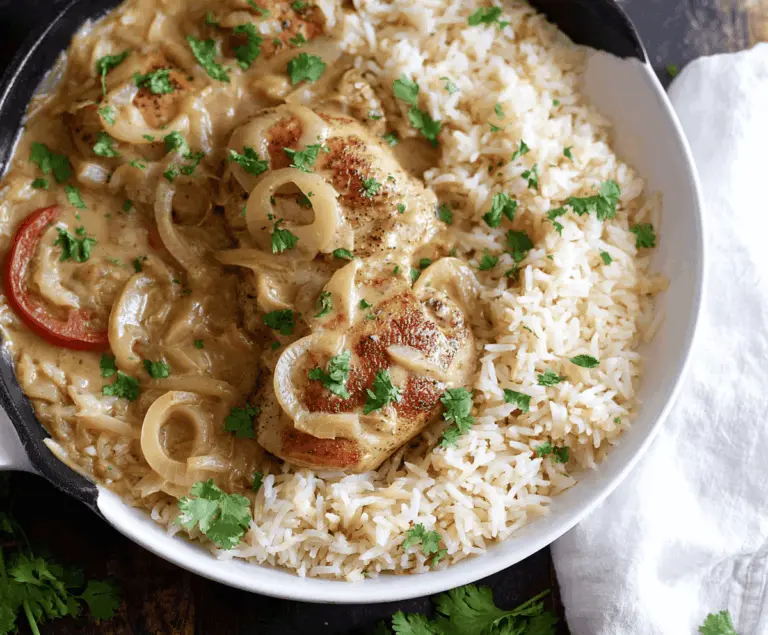 Delicious smothered chicken served over fluffy rice with flavorful gravy and fresh herbs