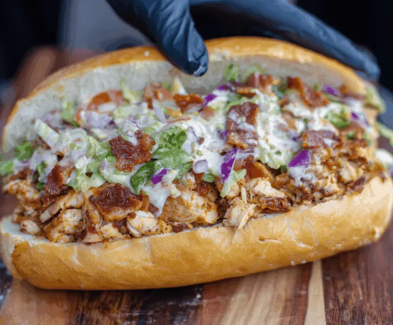 Delicious chopped chicken bacon ranch sandwich with crispy bacon, tender chicken, fresh lettuce, and creamy ranch sauce on toasted bread.