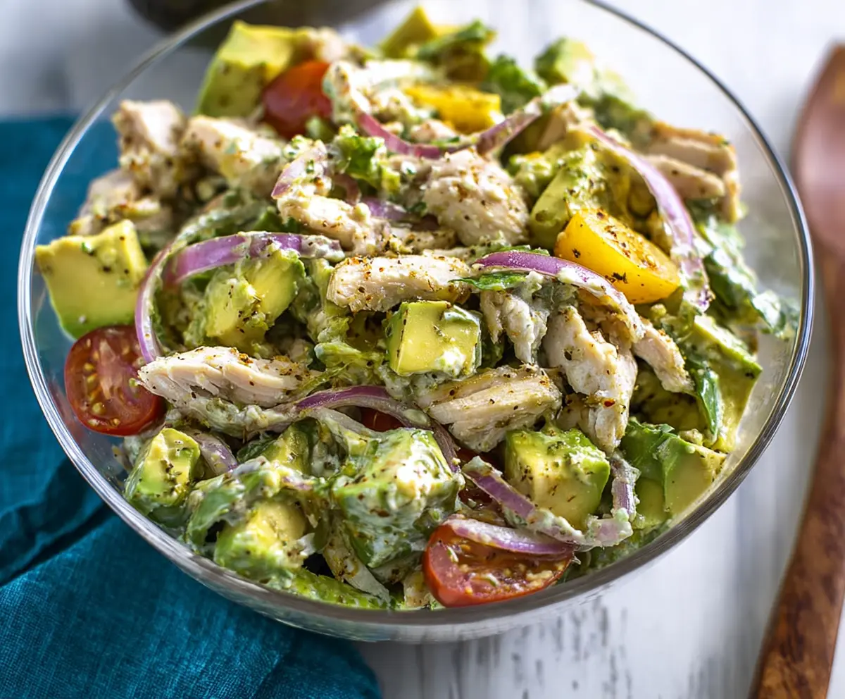 Creamy avocado chicken salad with fresh greens, perfect for healthy lunches and low-carb diets.
