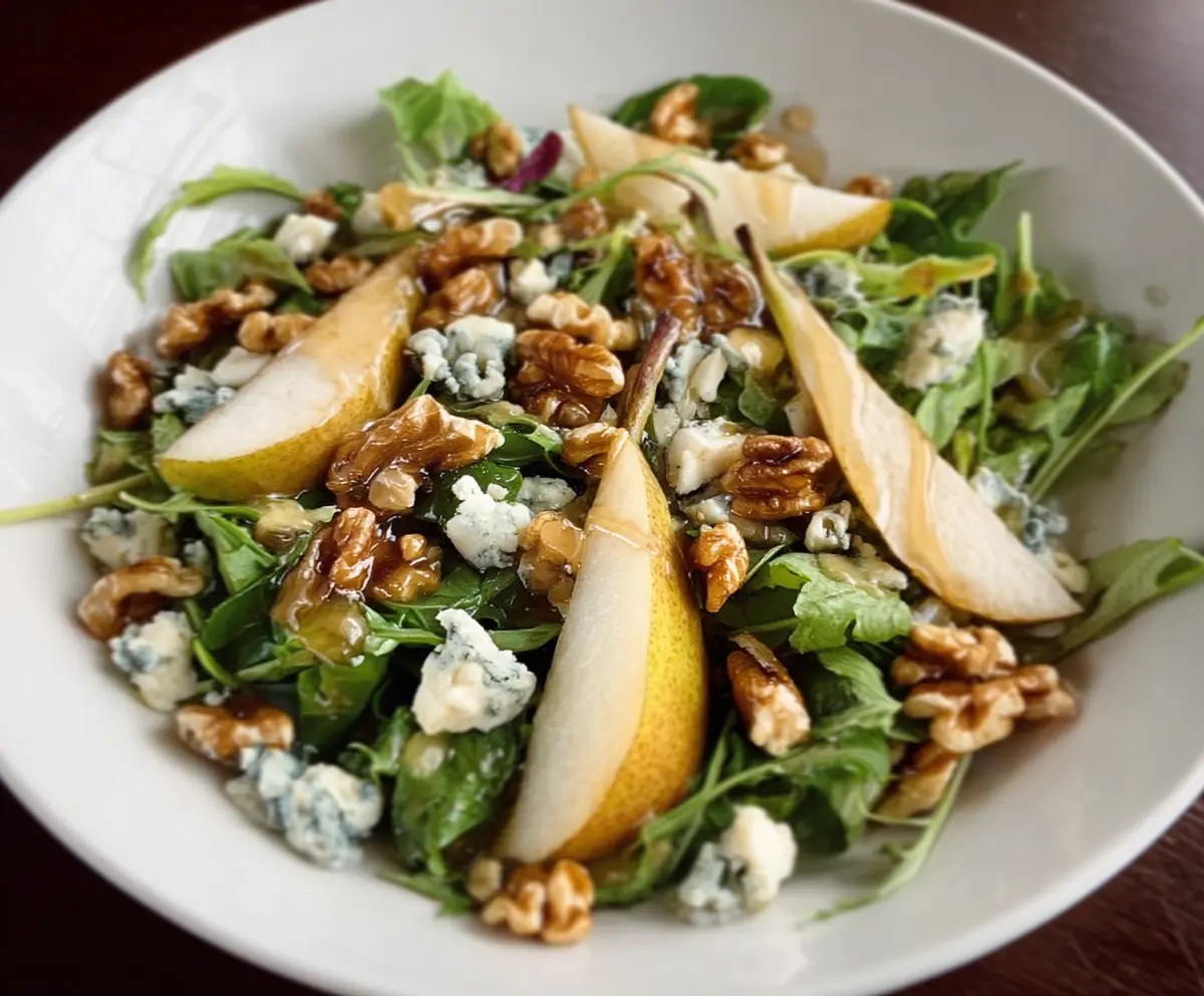 Fresh Pear & Gorgonzola Salad topped with Candied Walnuts, vibrant and appetizing.