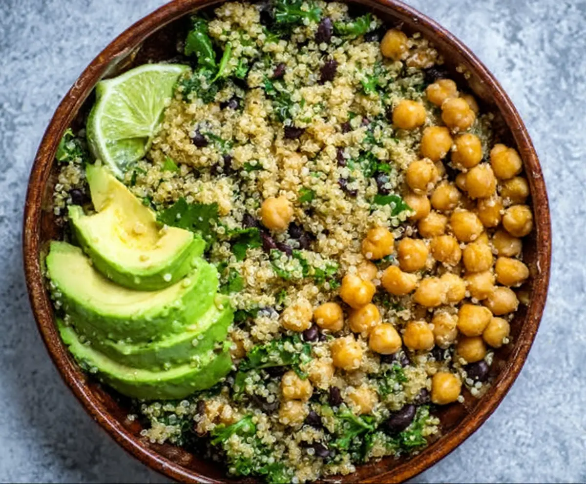 Bright and healthy quinoa bowl topped with ripe avocado slices and chickpeas, perfect for a nutritious vegetarian meal.