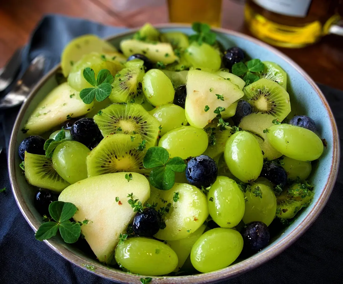 Colorful green fruit salad for St. Patrick’s Day with melons, grapes, and kiwi.