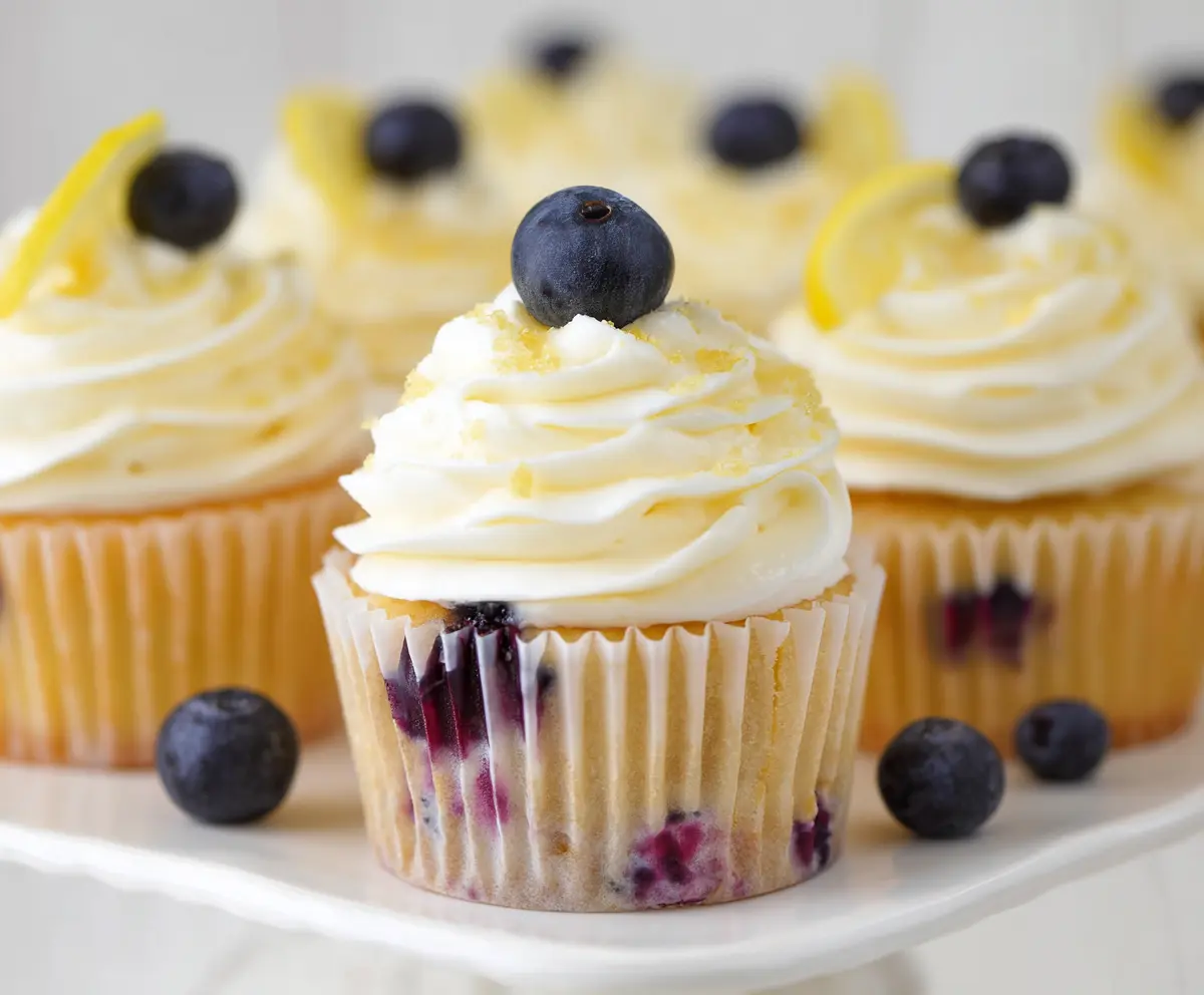 Delicious Lemon Blueberry Cupcakes topped with fresh blueberries and lemon zest.