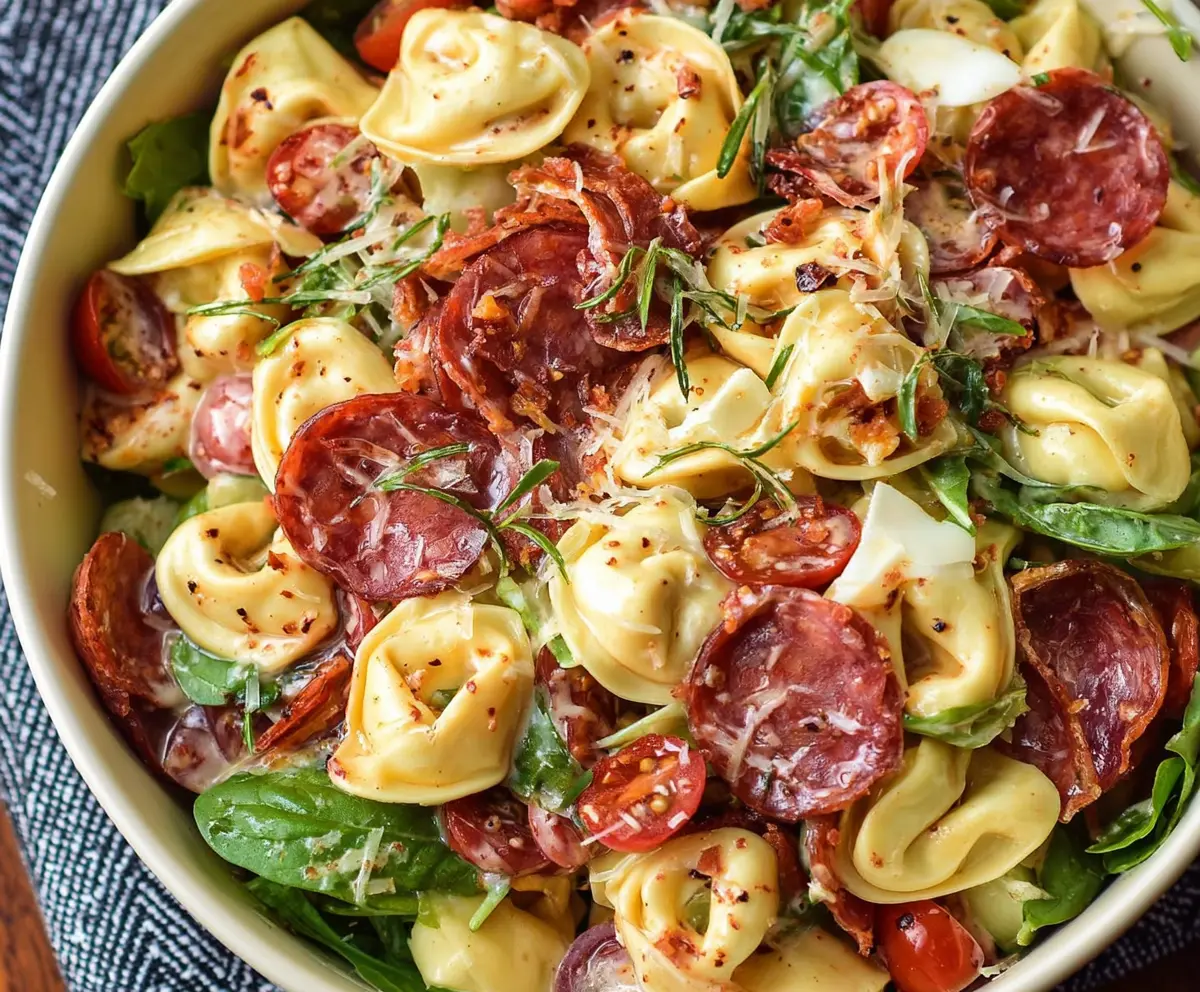 Colorful Salami Mozzarella Tortellini Pasta Salad with fresh herbs and vegetables